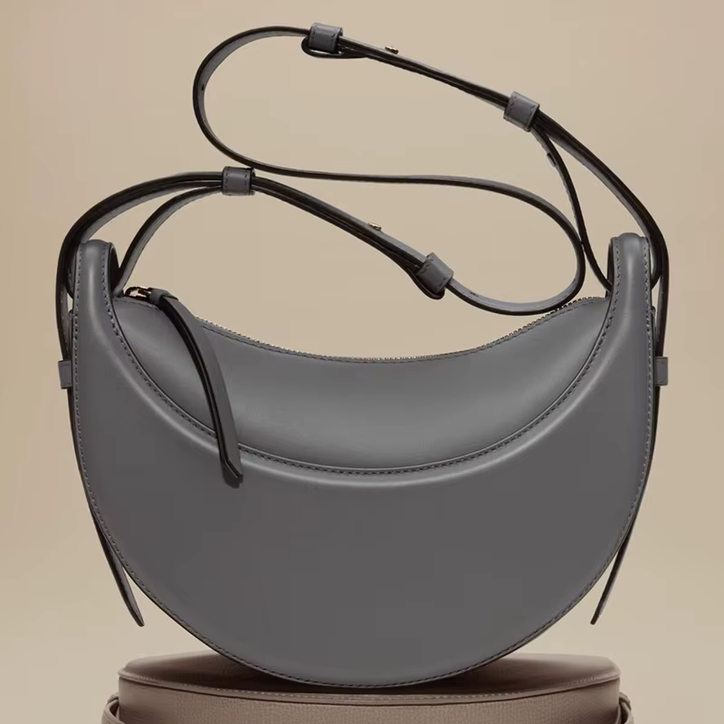 Sac à bandoulière pour femme en cuir véritable, style croissant, design original avec fermeture écla